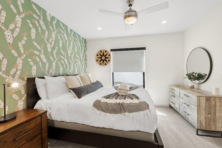 Loving the vibe of this bedroom super cozy with a touch of desert charm! That cactus wallpaper makes a fun statement, while the modern furniture and lighting keep things calm and comfy. Definitely a standout space that feels both relaxing. 