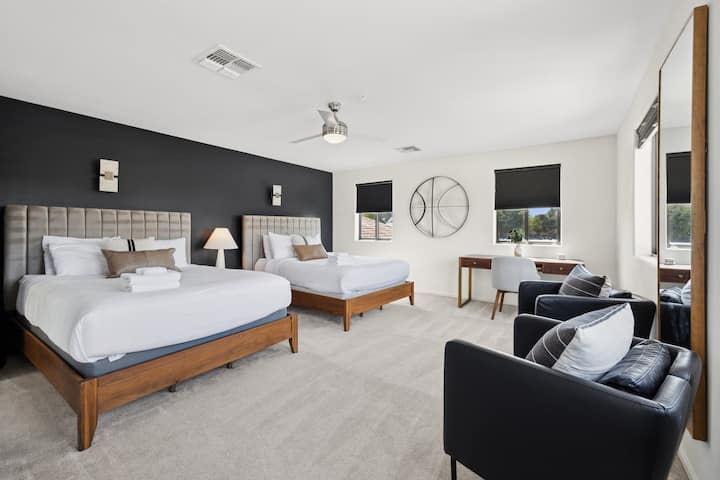 The upstairs bedroom is incredibly spacious, featuring two queen-size beds and a walk-in closet. It also includes a work-from-home desk, making it perfect for both relaxation and productivity.