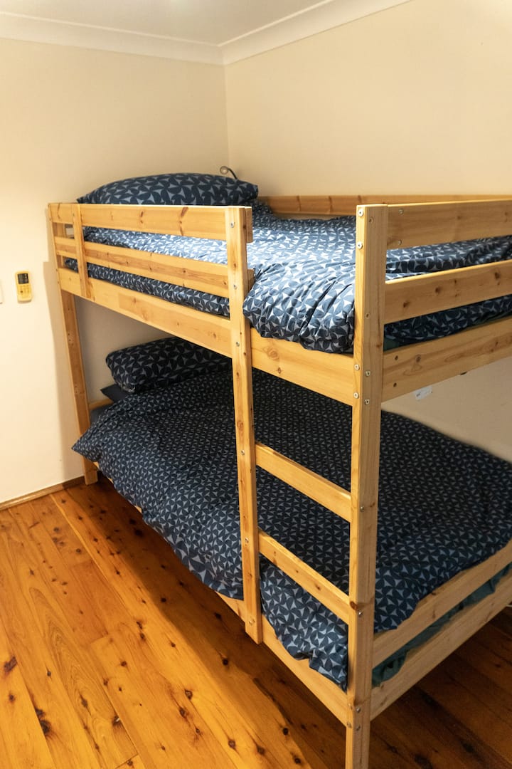 Bunks suitable for two children or one adult, mounted bedside lamps, reverse cycle air conditioning