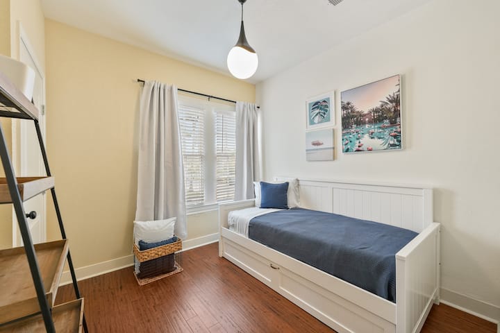 This charming third bedroom is designed for versatility, featuring a daybed with a convenient twin-sized trundle.