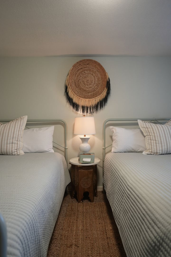 This inviting fourth bedroom is designed for comfort and convenience, featuring two plush queen beds that provide ample sleeping space for families.