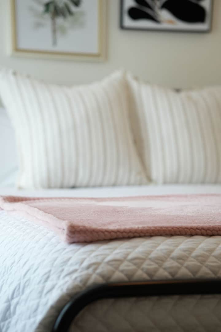 Emphasizing both style and practicality, this spacious bedroom features a king-size bed with elegant bedding and a sleek dresser for storage.