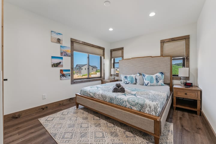 ห้องนอนที่ 2 มีเตียงคิงไซส์ โต๊ะข้างเตียง นาฬิกาปลุกพร้อมพอร์ต USB และตู้เสื้อผ้าพร้อมไม้แขวนเสื้อ