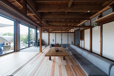 Azemichitaneru, a traditional kominka-style house with a bonfire pit, sauna, and rice fields