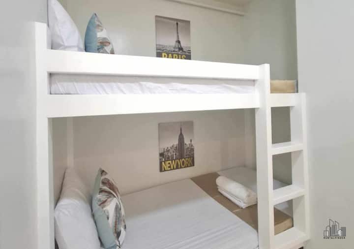 Comfortable bunk bed setup with fresh linens and soft pillows, perfect for families or small groups. This cozy sleeping space offers air-conditioning, clean towels, and a relaxing atmosphere.