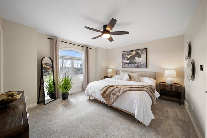 La chambre principale spacieuse comprend un lit king size avec des draps doux, un ventilateur de plafond, une grande baie vitrée et une salle de bain attenante. Profitez d'un dressing, de lampes de chevet, d'une télévision connectée de 50 pouces et de rideaux occultants pour un sommeil réparateur.