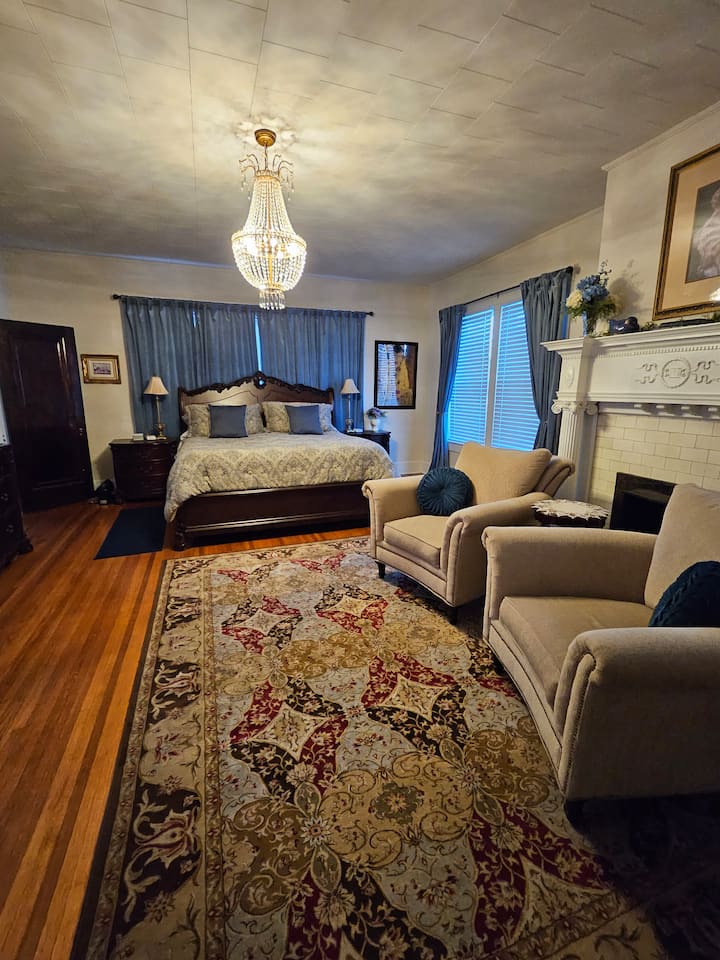 Extra large Master suite with king size bed, luxury linens, feather pillows, private bath, sitting area, chandelier, 65 inch flat screen TV, mini fridge stocked with water and snacks and full breakfast for 2 guests