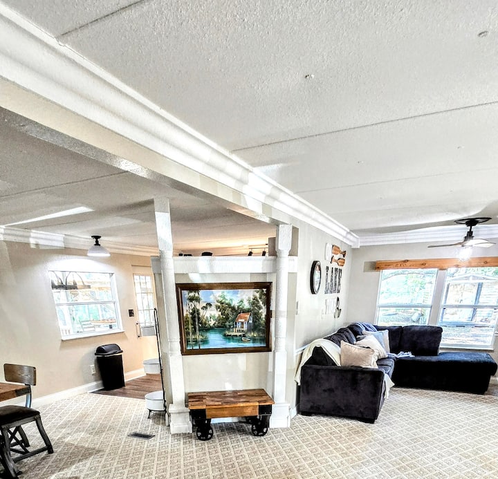 To the right is a sleeper couch, to the left is the dining table and kitchen around the corner
