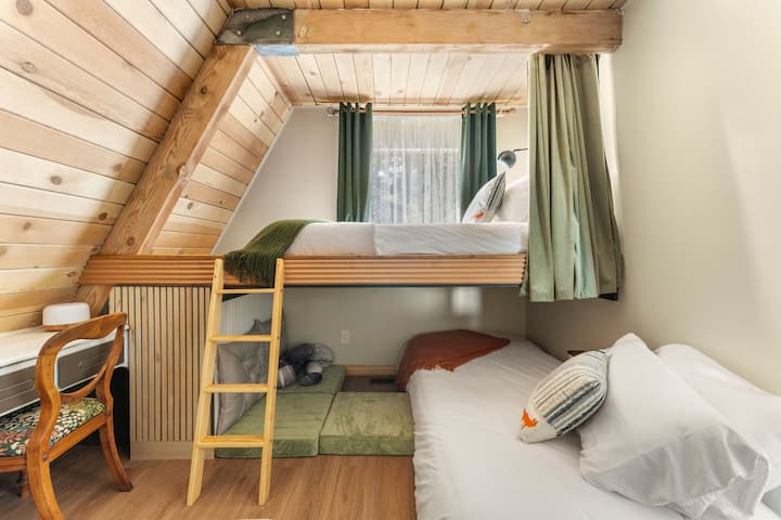 Custom Twin XL bunk beds designed for comfort and privacy. The top bunk features privacy curtains, while the bottom bunk offers a cozy reading nook.