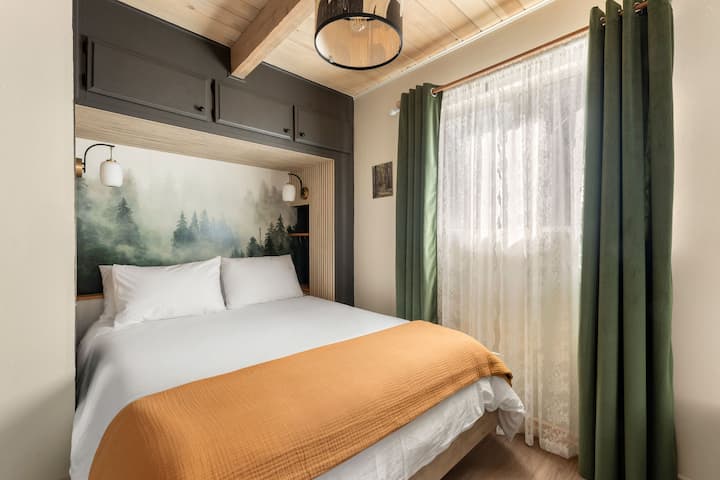 A cozy nook featuring a queen bed with 100% Egyptian cotton sheets, pillowcases, and duvet. An armoire provides convenient storage, while room-darkening shades create the perfect setting for a restful night's sleep.