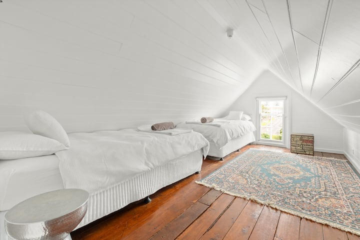 Two single beds located in upstairs bedroom