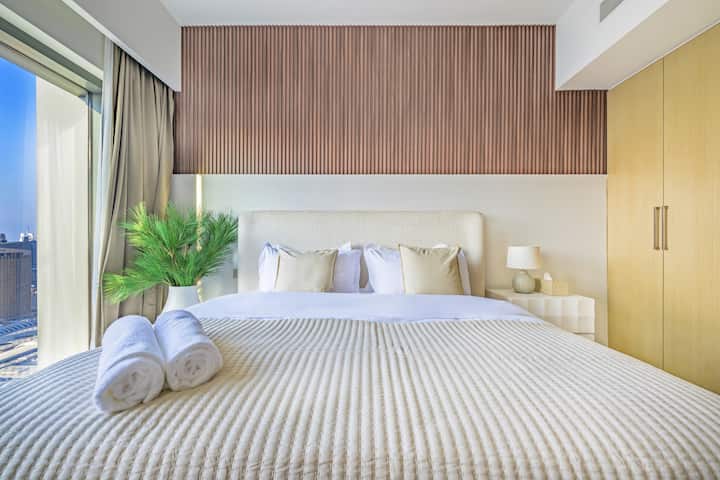 Elevate your stay with a bedroom that combines elegance and breathtaking views of the Burj Khalifa. Wake up to the mesmerising Burj Khalifa. Equipped with a smart television, wardrobe and a console table, the master bedroom has an attached bathroom.