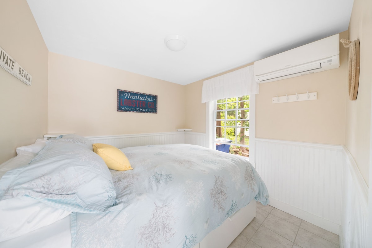 Back bedroom offers a queen size bed with under the bed drawers and plenty of hooks for hanging garments and beach towels