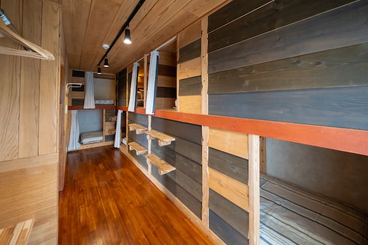 За разлика од обичните кревети на спрат, тие се направени по мерка и поставени во зградата, така што се цврсто изградени и безбедни.Тоа е удобен простор за кревет кој обезбедува приватност дури и за групни патувања.
Секој простор има завеси за затемнување.

Спална соба 2 има 3 единечни кревета и 3 полубрачни кревета.