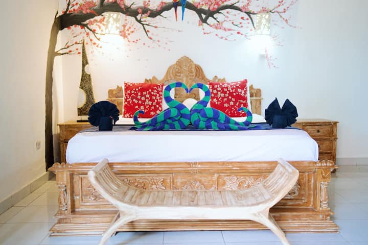 This is the downstairs bedroom in Villa 2, a spacious and airy retreat with an attached lounge area, offering plenty of room to relax and unwind.