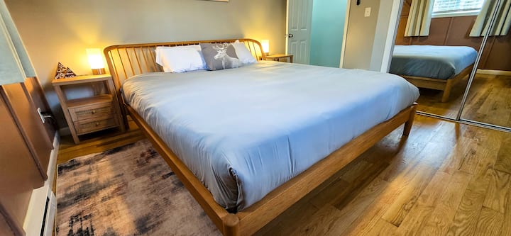 Bedroom Retreat: Experience restful nights on a spacious king-sized bed with stylish decor and warm lighting!