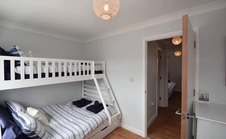 Comfy full double bed below and a single bed (suitable for children 6+) above, with generous storage.  Blinds and curtains double-up for your cosy lie-ins: solid sleep = great holiday! Chest of drawers and hanging rail to keep everything ship-shape.