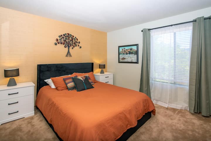 This bedroom features a queen-sized bed, with spacious nightstands, a closet, and blackout shades for a comfortable night's rest.