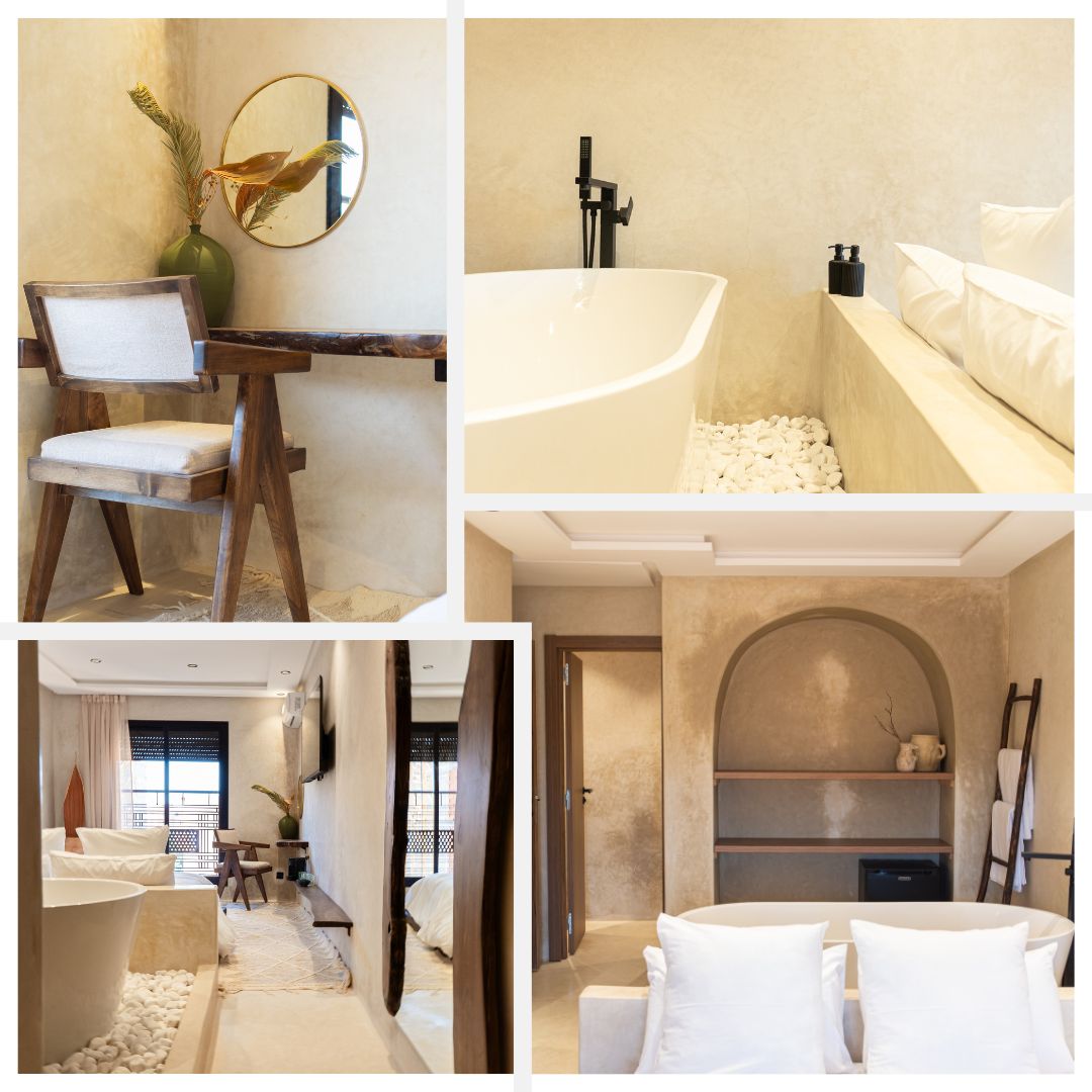 A serene workspace features a wooden desk paired with a chair, complemented by a round mirror and a decorative plant. The bathroom showcases a freestanding bathtub surrounded by smooth pebbles. The bedroom area is brightened by natural light, with a cozy seating arrangement and elegant design touches.