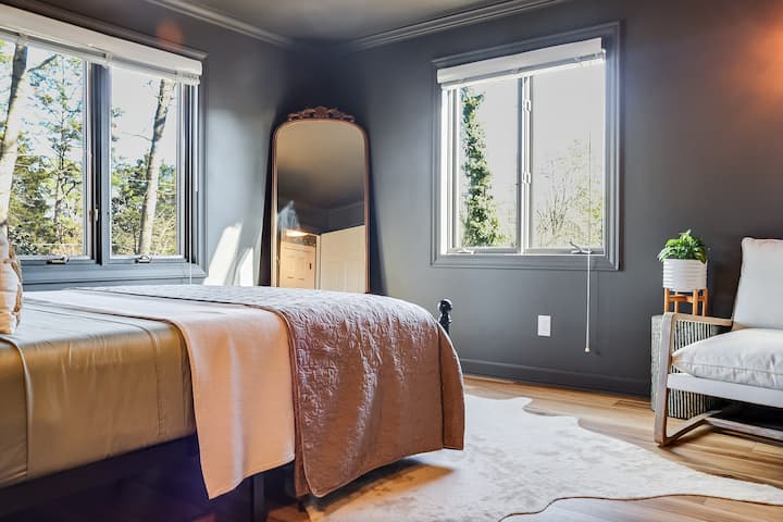 Დედოფლის ზომის საწოლი ბამბის თეთრეულითა და დამატებითი საბნებით კომფორტისთვის. 