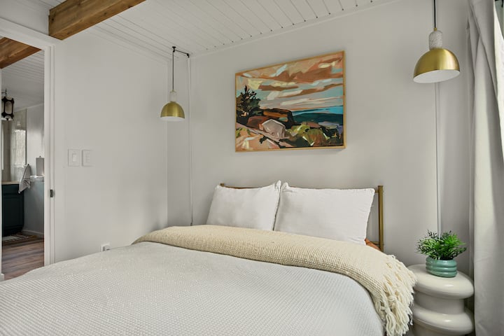 Serene Bedroom Retreat: Enjoy stylish decor, plush bedding, and beautiful mountain views!