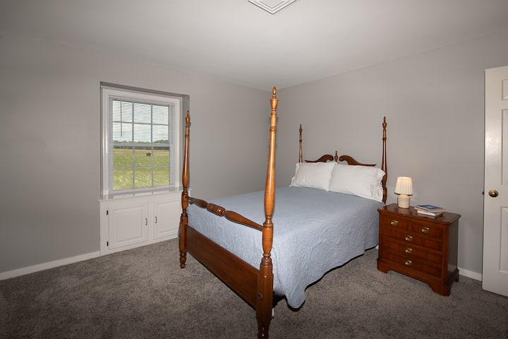 From this bedroom, you can see fields beside the house and across the road.  You may see cattle and sheep grazing.  This room also has a nice mountain view.