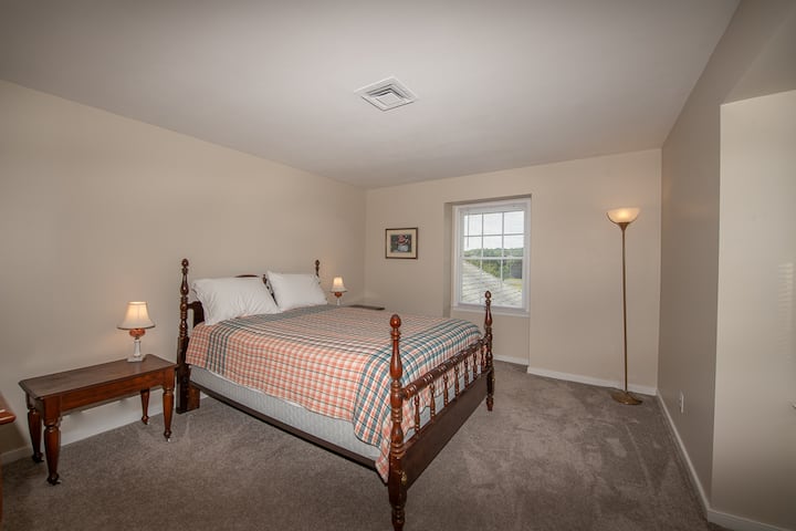 From this bedroom, you can see fields beside the house and across the road.  You may see cattle and sheep grazing.  This room also has a nice mountain view.
