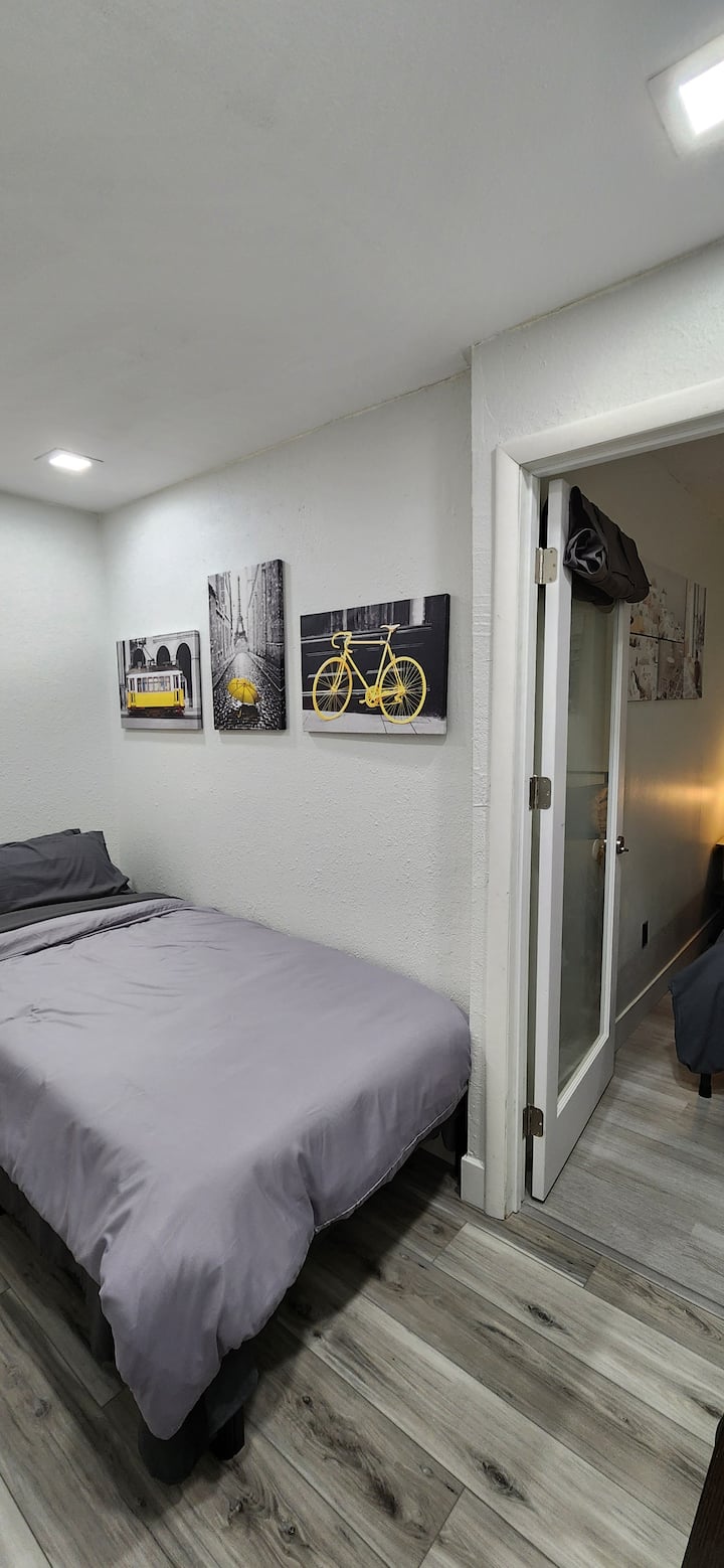 3rd small bedroom with a Twin XL bed, smart TV with cable, night stand, dresser, and small clothing rack.