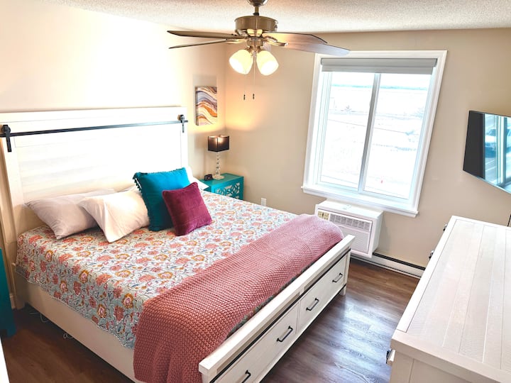 West facing primary bedroom with large screen television and window overlooking the marsh.  Private, controllable AC for those hot nights!