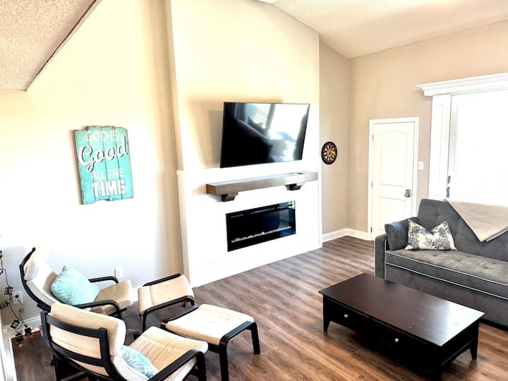 Comfortable living room with large screen television and couches.  View of the marsh and sunsets!