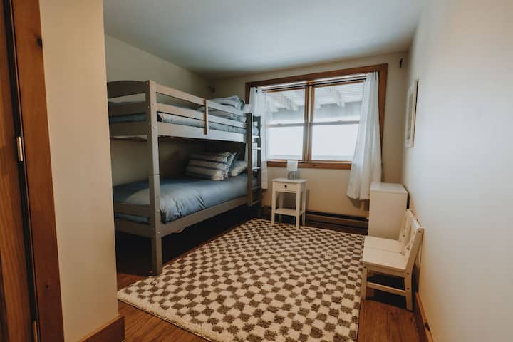 bunk bedroom on the lower level, with kid-sized furnishings