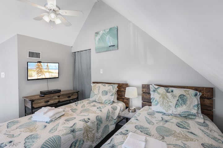 Peaceful and bright this room offers a soft retreat where gentle light and fresh linens promise a restful night