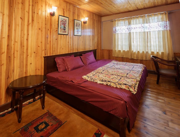 Enjoy a comfortable stay with a king-size bed, complemented by beautiful wooden flooring and all the essential amenities for a relaxing experience. The bed features a cozy 9-inch mattress, ensuring added comfort for a restful night's sleep.