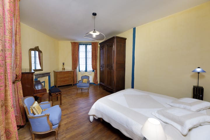 Single-storey bedroom with queen bed overlooking the garden courtyard.