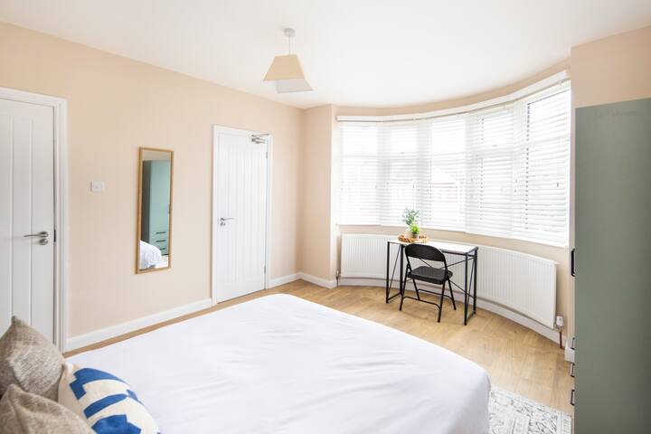 A spacious 16.76m² bedroom featuring a versatile zip-link double bed (can be two singles), a workstation, a cloth cabinet, two cabinet racks, a heater, and stylish lighting with a lampshade and fixture—perfect for work or relaxation.