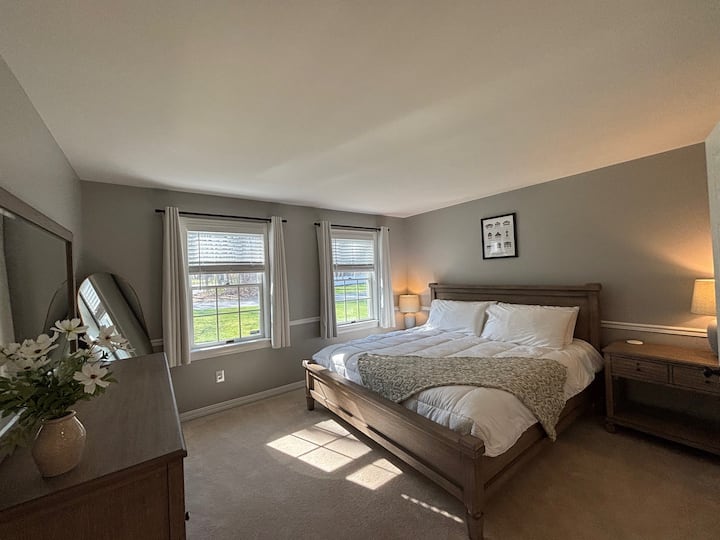 غرفة النوم 1 في الطابق السفلي وتتميز بأبواب فرنسية وسرير بمقاس كبير.