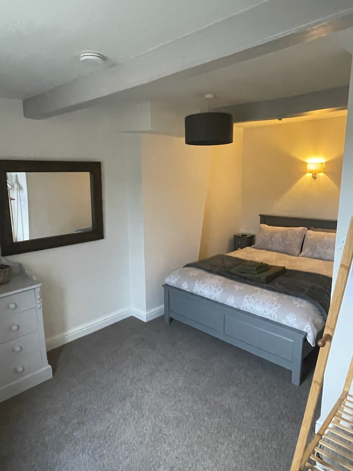 The bedroom with king-sized bed, framed wardrobe, hair dryer and a large walled mirror.  Bedding linen and towels are provided.  Guests are provided with a King-sized bed for your comfort however it does narrow the gap either side of the bed.