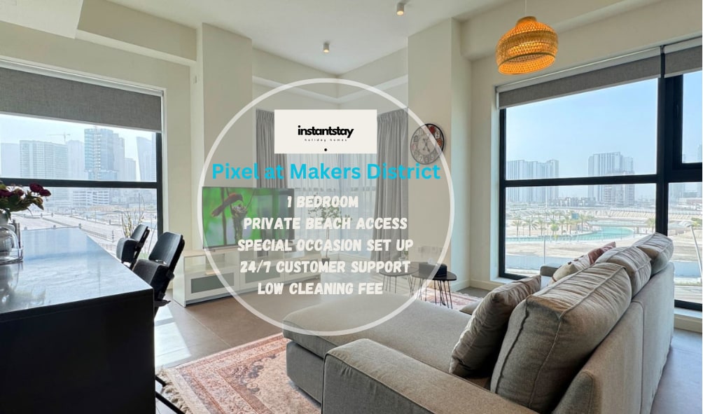 A stylish living area features a plush L-shaped sofa facing large windows that offer sweeping views of the surrounding landscape. Natural light floods the space, highlighting the modern design and open layout, creating an inviting atmosphere for relaxation and enjoyment.