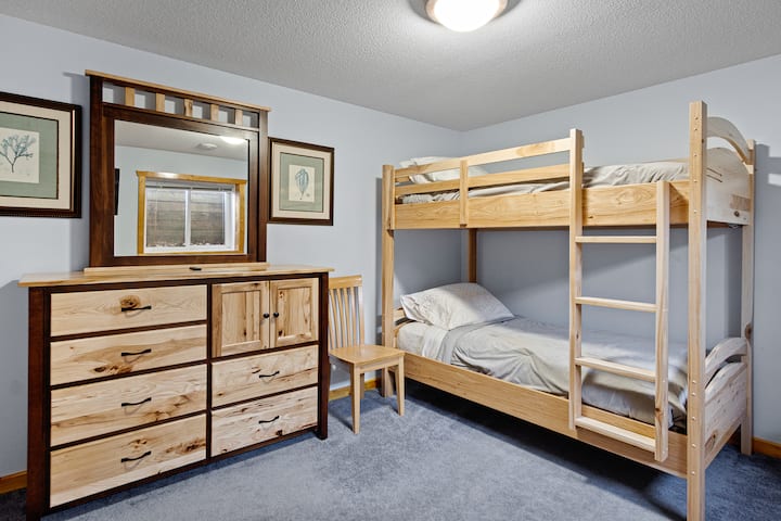 ห้องนอน 4: ห้องนอนชั้นล่างพร้อมเตียงสองชั้นทีวีตู้เสื้อผ้าและตู้เสื้อผ้า