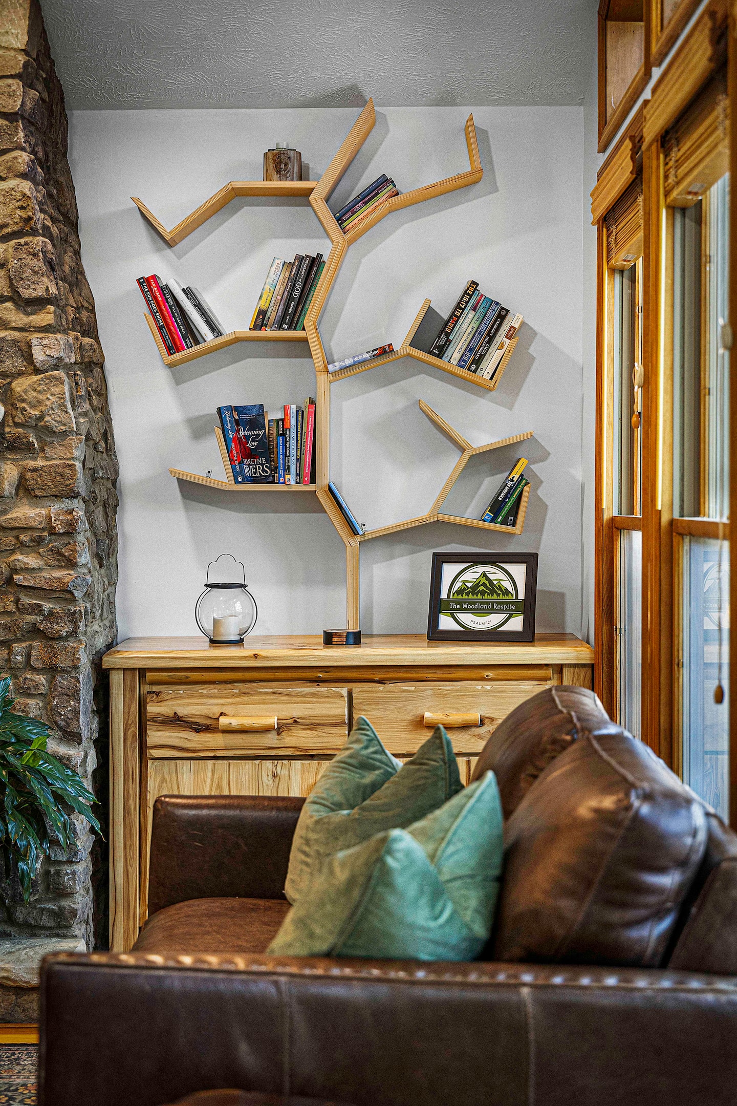 You'll spot the Woodland Respite sign tucked into the reading nook the second you walk in, a small detail that tells you