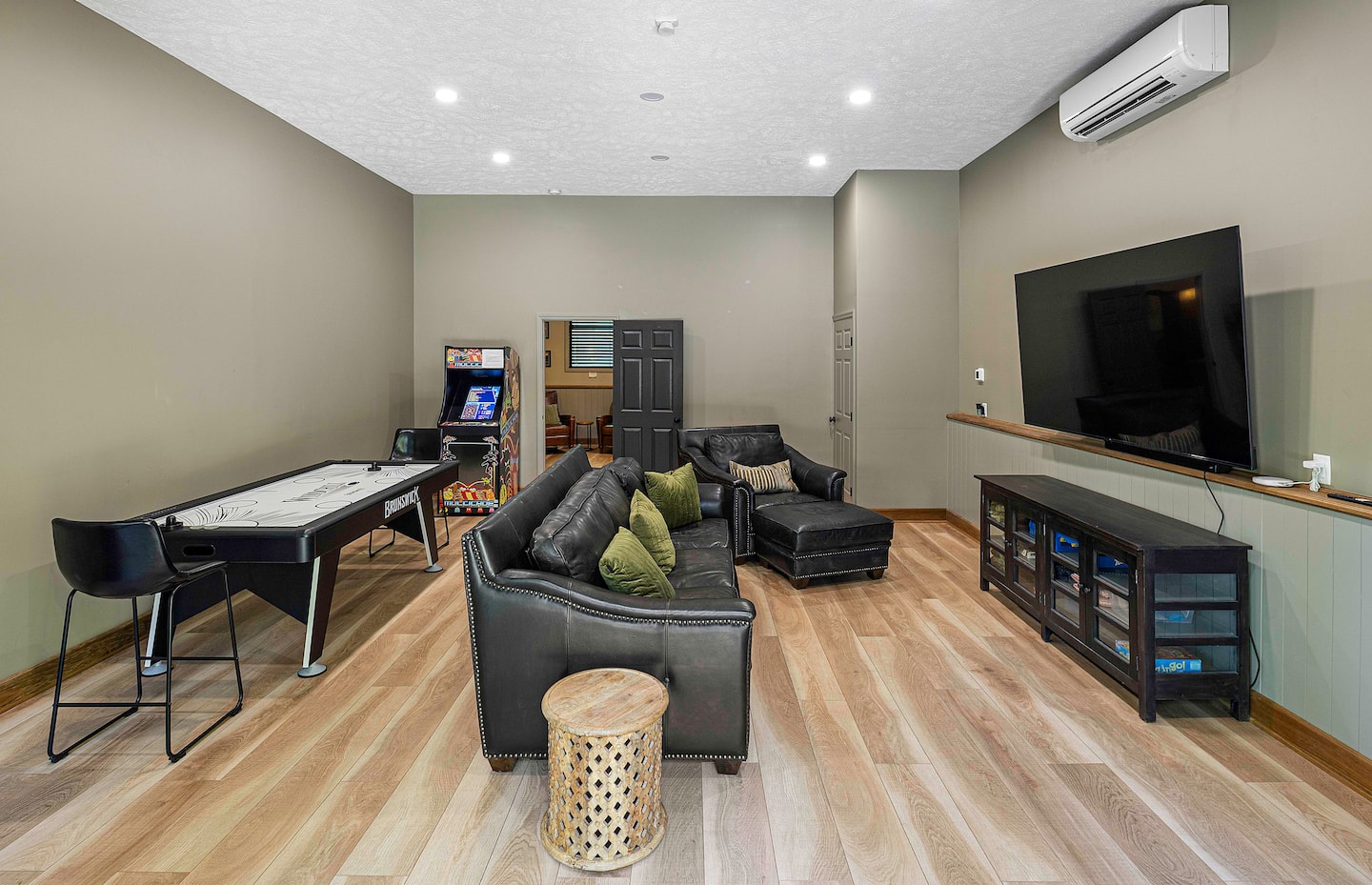 Guest house game room with arcade and air hockey table