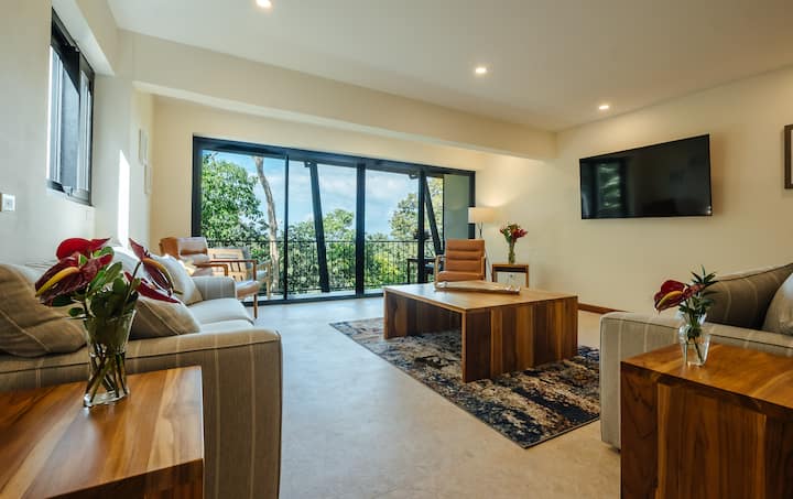 Family room with balcony doors and jungle views