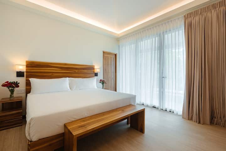 King suite with floor-to-ceiling sheer curtains