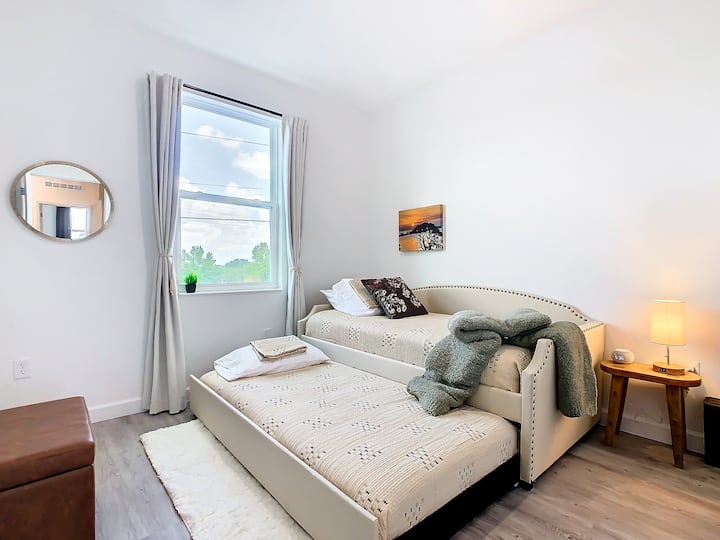 This stylish trundle bed is perfect for sharing a room. Choose to keep the beds together or place them apart, maximizing floor space. Enjoy black-out drapes, robes, a TV, a clock, and a lamp with a USB port for your convenience. 