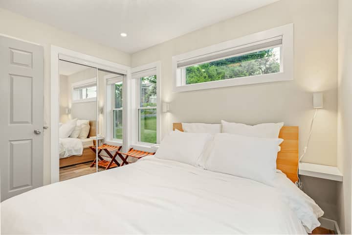 The private downstairs bedroom has a queen bed and pull down blinds