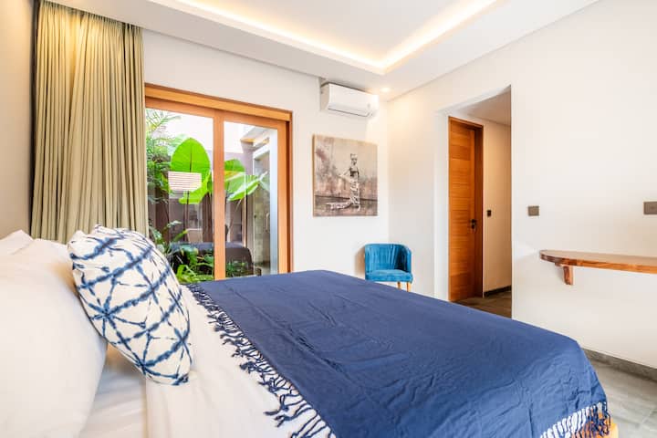 The 2nd bedroom features a queen bed and dedicated workspace with serene pool and garden views. Separated from the master bedroom and living area by the pool, it’s ideal for families or friends who want to stay close while enjoying their own privacy.