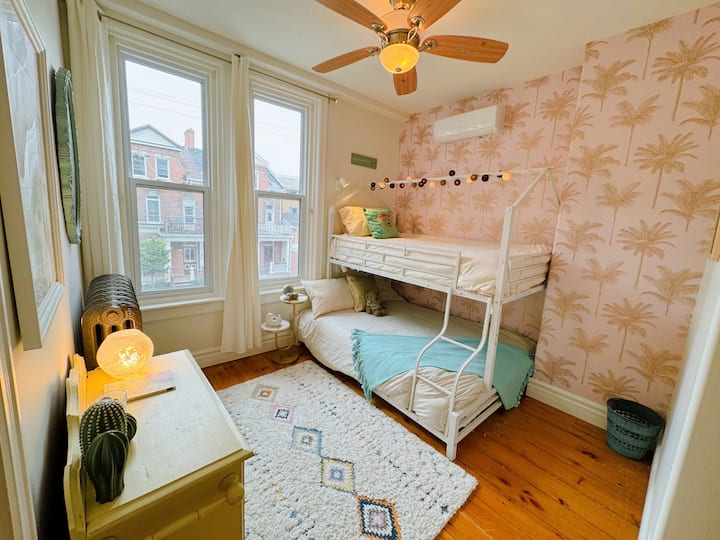 The Palm Tree Room
A bunk bed setup kids will love!  Comes with books, games, a travel crib,  nightlight, and all the cozy touches little ones need.   (Grown ups can sleep here too! It's a really high quality double bed on the bottom).
