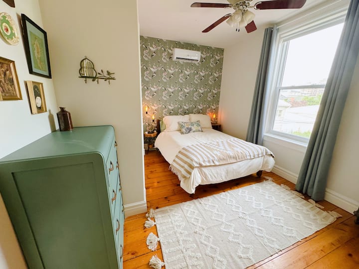 "The Pelican Room”
Features a double bed, desk, and whimsical wallpaper. A calm and inspiring space for work or rest.