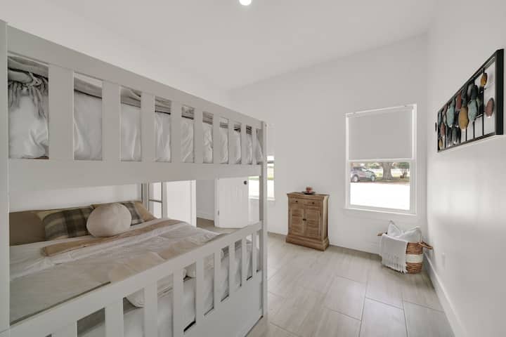 Perfect for families or groups, this bright guest room features sturdy bunk beds and plenty of natural light.