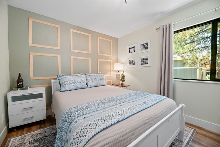 This upper level bedroom has 1 queen bed, a 43” Samsung TV with Roku, hardwood floor, and a closet.